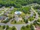 A high-angle view reveals a community pool with a play area surrounded by well-maintained homes and streets at 1017 Quail Run Ct, Indian Land, SC 29707