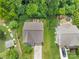 Birds-eye view of the home surrounded by mature trees, an adjacent home, and a spacious lawn at 1017 Quail Run Ct, Indian Land, SC 29707