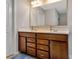 Bathroom with double sink vanity featuring dark wood cabinets, and a large mirror at 1017 Quail Run Ct, Indian Land, SC 29707