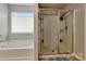 Bright bathroom featuring soaking tub and tiled shower with a glass door at 1017 Quail Run Ct, Indian Land, SC 29707