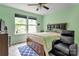 This cozy bedroom features a large window, a ceiling fan, and natural light at 1017 Quail Run Ct, Indian Land, SC 29707