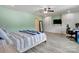 Spacious bedroom with built-in closet, desk, ceiling fan, and wood-look floors at 1017 Quail Run Ct, Indian Land, SC 29707