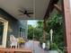 This covered patio has a swing and ample seating, making it great for enjoying serene garden views at 1017 Quail Run Ct, Indian Land, SC 29707