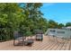 This beautiful deck features lounge furniture and a view of the surrounding trees at 1017 Quail Run Ct, Indian Land, SC 29707