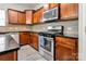 Well-lit kitchen featuring stainless steel appliances, wood cabinets, and granite countertops at 1017 Quail Run Ct, Indian Land, SC 29707