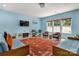 Bright living room with multiple windows, blue sofas, and wood look flooring at 1017 Quail Run Ct, Indian Land, SC 29707