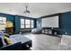 Finished basement with media room, large projector screen, and blue sectional sofa at 1017 Quail Run Ct, Indian Land, SC 29707