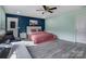 Bedroom featuring blue accent wall, a bed with pink cover, and workspace with a desk and chair at 1017 Quail Run Ct, Indian Land, SC 29707