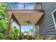 Charming covered patio with a ceiling fan, string lights, seating, and views of the landscaped backyard at 1017 Quail Run Ct, Indian Land, SC 29707