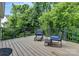 A back deck with outdoor seating, a black metal railing, and a view of the trees at 1017 Quail Run Ct, Indian Land, SC 29707