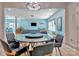 Modern dining area with dark table and chairs, open to a living area, hardwood floors, and stylish lighting at 1017 Quail Run Ct, Indian Land, SC 29707