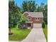Lovely two-story brick home with a well-maintained lawn and long driveway, surrounded by mature trees offering curb appeal at 1017 Quail Run Ct, Indian Land, SC 29707