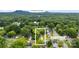 An aerial view of a home surrounded by lush trees, showcasing its location near Crowders Mountain at 104 E Louisiana Ave, Bessemer City, NC 28016