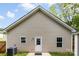 A view of the back exterior reveals a door and windows accented by a white trim at 104 E Louisiana Ave, Bessemer City, NC 28016