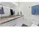 Bathroom features a double vanity with granite countertops, and tiled floor at 104 E Louisiana Ave, Bessemer City, NC 28016