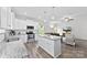 Open concept kitchen with island, granite counters, stainless steel appliances, and hardwood floors at 104 E Louisiana Ave, Bessemer City, NC 28016