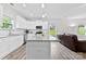 Bright, modern kitchen features white cabinets, granite countertops, and stainless steel appliances at 104 E Louisiana Ave, Bessemer City, NC 28016