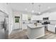 Modern kitchen with white cabinets, stainless steel appliances, a center island, and granite countertops at 104 E Louisiana Ave, Bessemer City, NC 28016