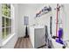 This laundry room features a washer and dryer set, neutral walls, and practical storage at 104 E Louisiana Ave, Bessemer City, NC 28016