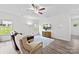 Bright living room with hardwood floors, a comfortable seating area, and a large window showcasing the outdoor view at 104 E Louisiana Ave, Bessemer City, NC 28016