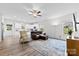 Open-concept living space features hardwood floors, modern ceiling fan, with abundant natural light and neutral paint at 104 E Louisiana Ave, Bessemer City, NC 28016