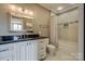 Bright bathroom featuring a granite countertop, white cabinets, and combination shower and bathtub at 109 Oak Forest Dr, Kings Mountain, NC 28086