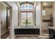 Spa-like bathroom with soaking tub, large window, and modern fixtures at 109 Oak Forest Dr, Kings Mountain, NC 28086