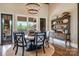 Elegant dining room with stylish chandelier, hardwood floors, and backyard views at 109 Oak Forest Dr, Kings Mountain, NC 28086