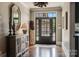 Inviting foyer with hardwood floors, decorative mirror and front door with sidelights at 109 Oak Forest Dr, Kings Mountain, NC 28086
