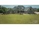 Beautiful stone and brick home featuring a lush green lawn and manicured landscaping at 109 Oak Forest Dr, Kings Mountain, NC 28086