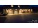Charming home featuring 3-car garage, brick accents, stone trim, and inviting lighting at 109 Oak Forest Dr, Kings Mountain, NC 28086