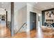 Bright hallway featuring hardwood floors, wooden accents, modern lighting, and staircase at 109 Oak Forest Dr, Kings Mountain, NC 28086