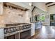 Gourmet kitchen featuring a professional-grade range, custom backsplash, and open layout at 109 Oak Forest Dr, Kings Mountain, NC 28086