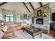 Inviting living room features a stone fireplace, beamed ceiling, and comfortable leather sectional at 109 Oak Forest Dr, Kings Mountain, NC 28086
