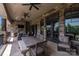 Outdoor seating area with stone fireplace, ceiling fans, and comfortable furniture for relaxation at 109 Oak Forest Dr, Kings Mountain, NC 28086