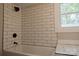 Bathroom featuring a white subway tile shower with black fixtures at 112 Hampton St, Chester, SC 29706