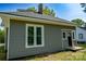 Exterior of home showing the well-maintained gray siding, trim, and a convenient side entry, set on a lush lot at 112 Hampton St, Chester, SC 29706