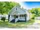 A beautiful view of the home showcasing its well-maintained landscaping, inviting front porch, and architectural details at 112 Hampton St, Chester, SC 29706