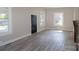 Bright living room featuring a decorative brick fireplace, multiple windows, neutral paint, and modern flooring at 112 Hampton St, Chester, SC 29706