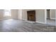 Bright living room featuring a brick fireplace and new wood flooring at 112 Hampton St, Chester, SC 29706