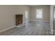 Inviting living room showcasing a decorative brick fireplace, neutral paint, and modern floors for a cozy ambiance at 112 Hampton St, Chester, SC 29706