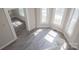 Open living room featuring grey laminate flooring, white trim, and large windows at 112 Hampton St, Chester, SC 29706