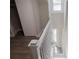Open staircase featuring wood-look flooring, white trim, and natural light at 112 Hampton St, Chester, SC 29706