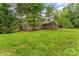 Expansive backyard with lush green grass and mature trees, creating a serene outdoor oasis at 121 33Rd Ne Ave, Hickory, NC 28601