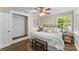 Comfortable bedroom features closet, ceiling fan, hardwood floors, and bench at 121 33Rd Ne Ave, Hickory, NC 28601