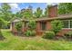 Charming brick home features a cozy front porch and lush landscaping around the entrance at 121 33Rd Ne Ave, Hickory, NC 28601