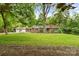 Traditional brick home featuring a manicured lawn and mature trees enhancing its curb appeal at 121 33Rd Ne Ave, Hickory, NC 28601