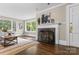 Cozy living room with hardwood floors, a fireplace, and a view of the lush outdoors at 121 33Rd Ne Ave, Hickory, NC 28601