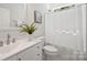 Well-lit bathroom with a white vanity, a plant, and a shower with a white curtain at 126 Meadow Glen Dr, Troutman, NC 28166