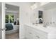 Bright bathroom featuring a double sink vanity and a view into the bedroom at 126 Meadow Glen Dr, Troutman, NC 28166